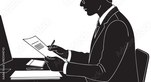 Silhouette of businessman in suit reviewing document at desk