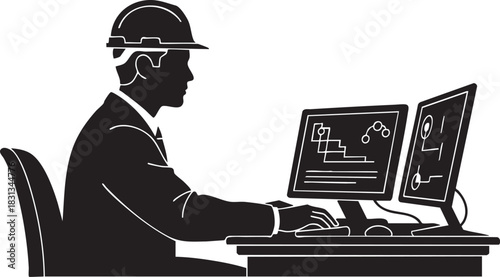 Silhouette of engineer in hard hat working on dual computer monitor