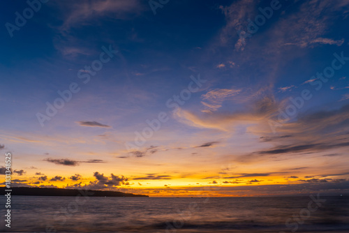 Sunset sky over sea in the evening, Dusk sky horizon. Fiery orange sunset paints sky. Golden hour magic, breathtaking horizon, peaceful evening.