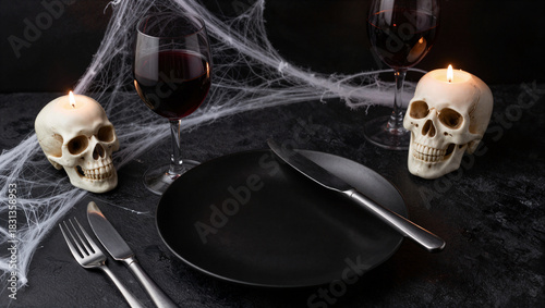 Spooky halloween dinner setting with skull decor and red wine indoor tabletop festive atmosphere