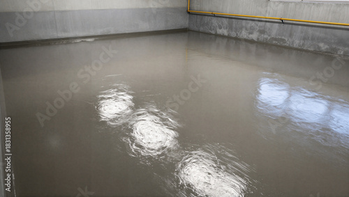 Flooded concrete floor installation in urban warehouse construction process indoor industrial setting perspective on new projects