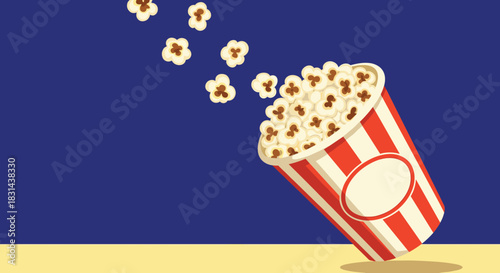 A striped popcorn bucket spills its contents onto a beige surface with a blue background.