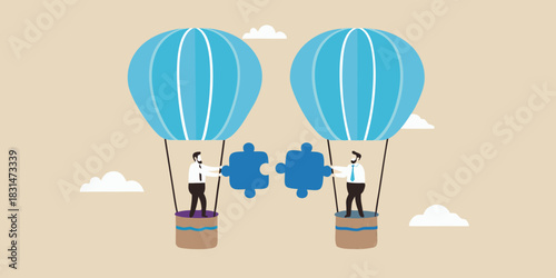 Businessmen in hot air balloons connecting puzzle pieces
