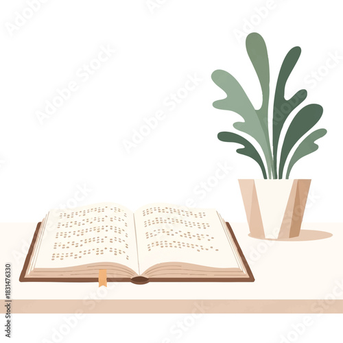 Flat lay of an open book next to a potted plant on a table against a white background with a minimalist composition.