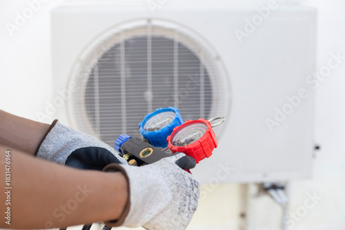 Air conditioner technician checks air conditioner fluid and refill coolant. Air conditioner service.