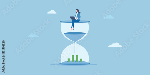 Businesswoman working on laptop on top of hourglass with financial chart below