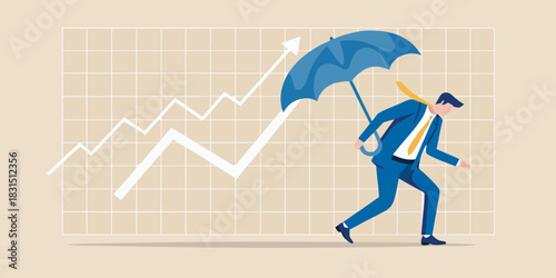 Businessman with umbrella protects rising financial graph