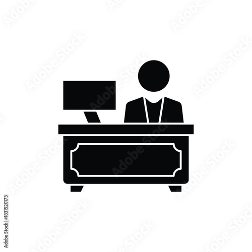 Black silhouette icon of a person working at a desk with a computer, representing an office worker or professional.