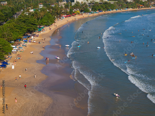 Aerial view of Weligama Beach with surfers riding the waves, Sri Lanka
