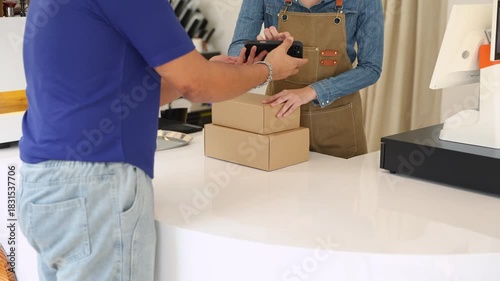 Deliveryman confirming parcel with cafe owner woman using smartphone, representing digital signature, cashless payment, efficient collaboration between delivery service and small business logistics