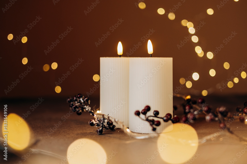 Obraz premium Advent white candles with decor in shiny lights closeup