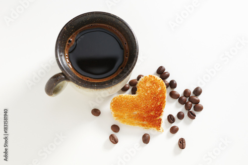 Coffee and toast with heart shape cutout