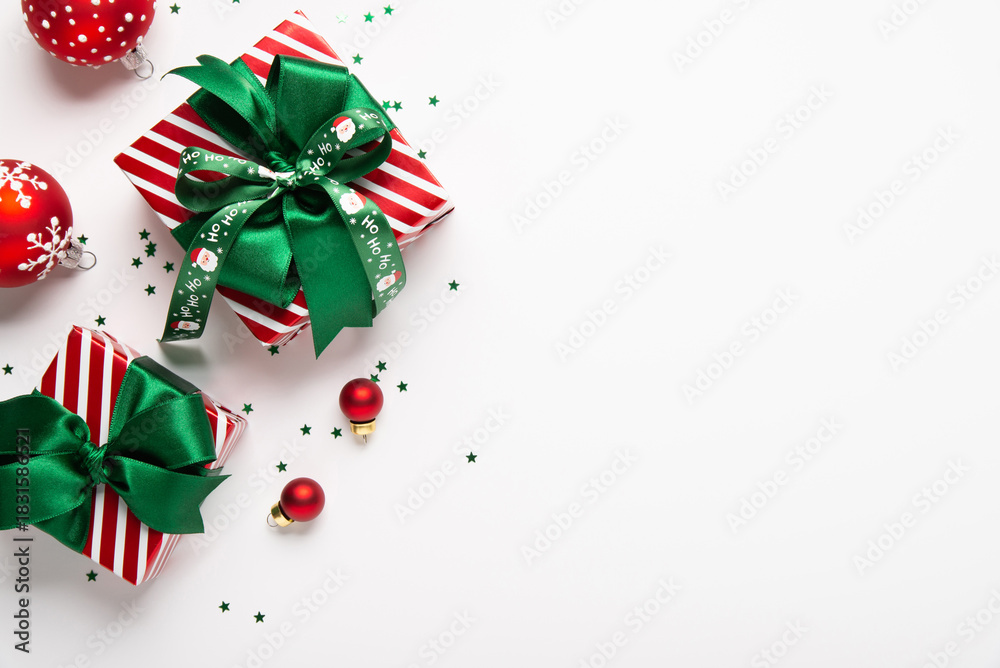 Obraz premium Merry Christmas and Happy Holidays greeting card, frame, border, banner. New Year. Red green Christmas decoration, ornaments and gifts, presents on white background. Xmas holiday festive theme.