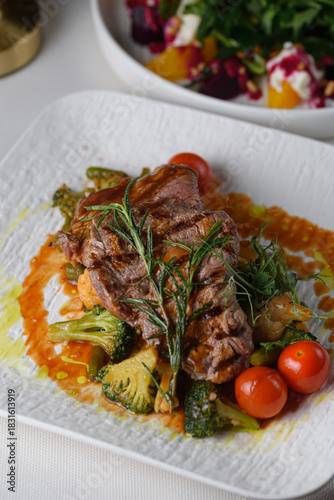 beef medallions with vegetables in sauce