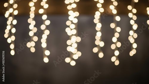 Warm blurred bokeh lights hanging in a festive indoor setting