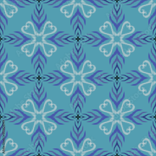 Seamless floral-inspired ikat pattern in blue and teal hues, featuring soft symmetrical motifs. Perfect for fabrics, wallpapers, gift wrapping, and digital design projects.