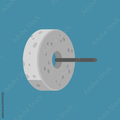 Gray stone wheel with holes and a rod going through the center.