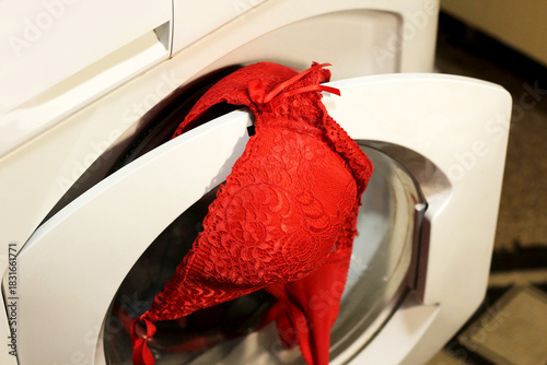 Red women's lingerie and an automatic washing machine.
