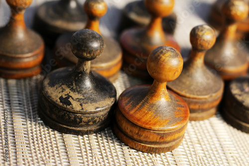 Old retro wooden chess pieces, intellectual strategy game.