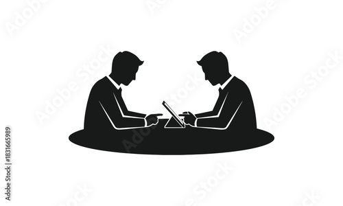 Two businessmen working together at a table.