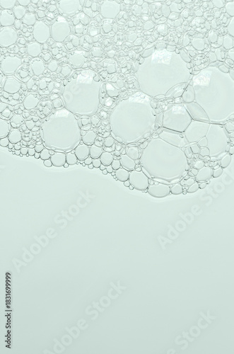 The texture of the foam of shower gel or soap suds or shaving foam. Macrophotography. Copy space