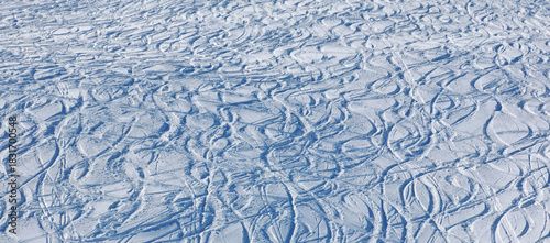 Powder snow with ski and snowboard tracks,winter background, Switzerland.