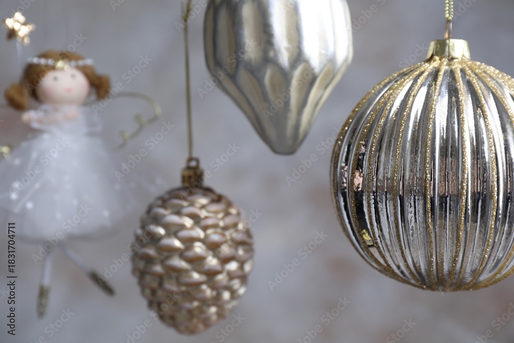 Naklejka premium Beautiful Christmas decor hanging near light grey wall, closeup