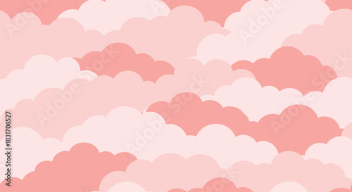 A gentle pastel pink sky filled with soft fluffy clouds at sunrise.