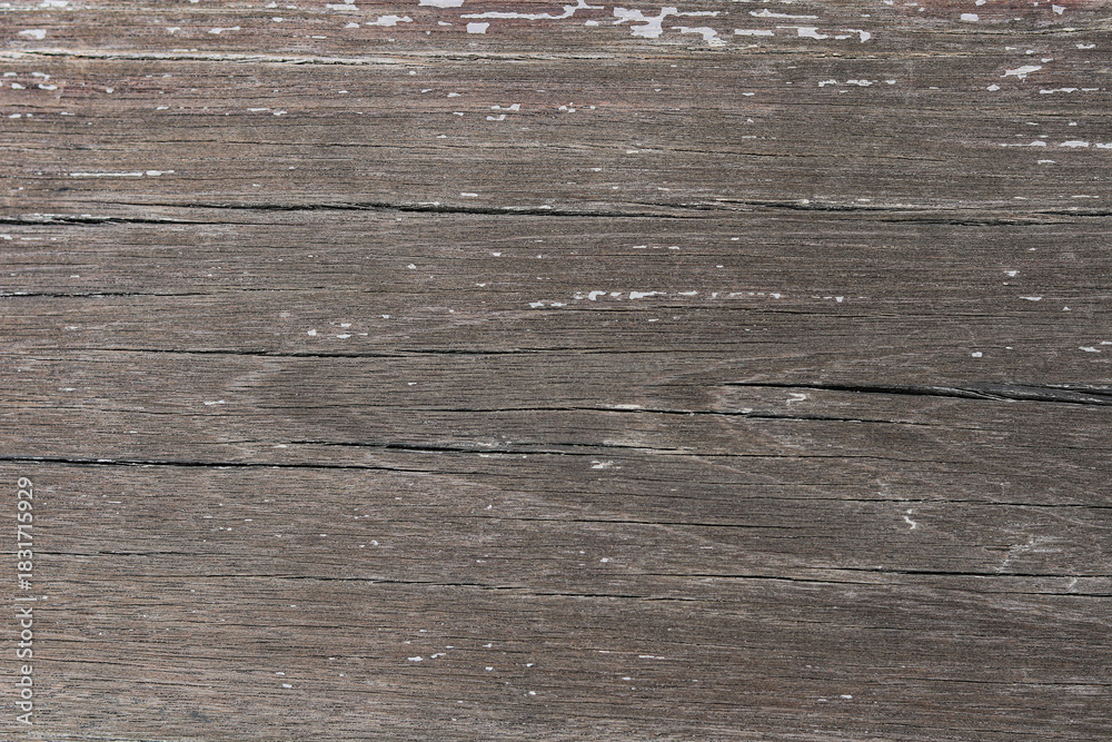 Naklejka premium A richly textured, close-up view of distressed wood. The deep gray-brown planks feature prominent grain patterns and natural cracks, giving a rustic, time-worn feel.