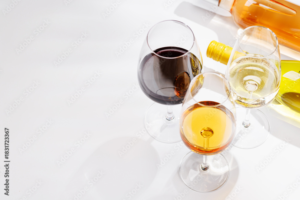 Fototapeta premium Different wine bottles and glasses on white background