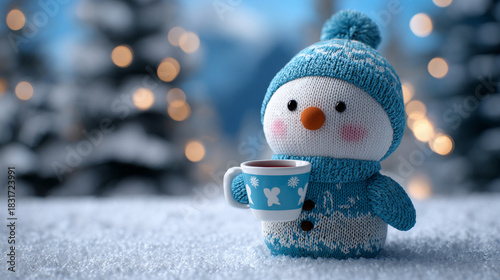 A cute plush snowman toy holding a mug sits in a snowy setting, offering a cozy holiday gift idea for children.