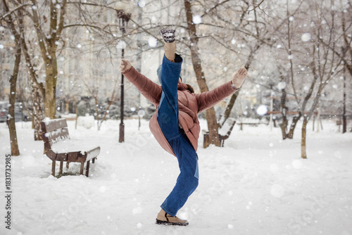 Slide down in Winter. Girl Teen Sliding and Falling down on Slippery Ice Road in Snow Weather. Winter Accident Insurance.