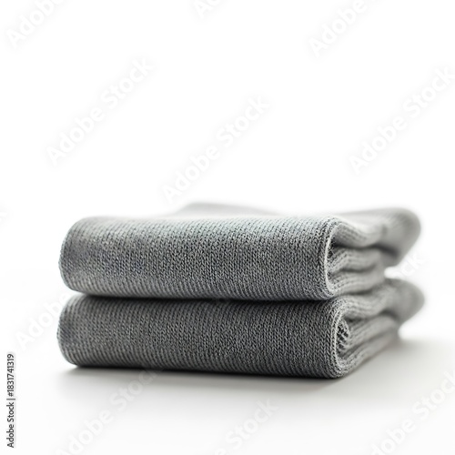 Two soft gray bath towels stacked neatly on a white background