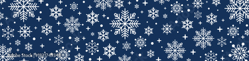 Festive seamless dark blue and white Christmas pattern with decorative snowflakes, falling snow and stars, holiday winter background for greeting cards, wrapping paper and seasonal designs