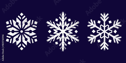 Three white grunge snowflakes on a dark blue background