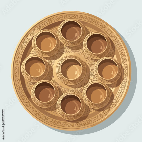 Elaborate Seder plate with intricately decorated bowls in golden hues