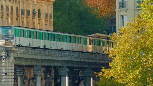 Paris, France - 26.08.2025 : The parisian urban subway passes over a bridge. The oldest green metro line, number 6 in Paris
