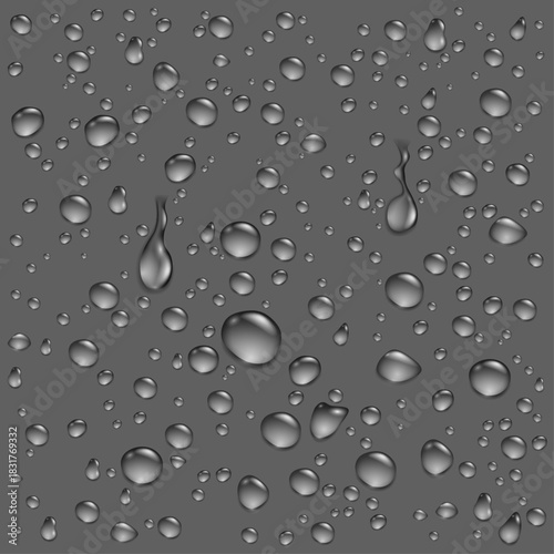 A collection of clear, realistic water droplets and condensation on a smooth dark grey surface.