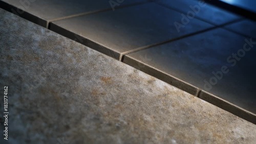 Wallpaper Mural Closeup of textured surface transitioning to smooth tiles under light Torontodigital.ca