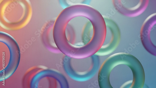 Floating colorful torus shapes with iridescent material on a blurred gradient background