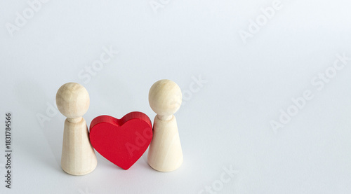 Wooden couple figures with red heart symbolizing love relationship union affection connection together