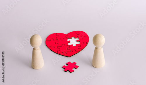 Couple figures with missing heart puzzle piece symbolizing love connection relationship concept