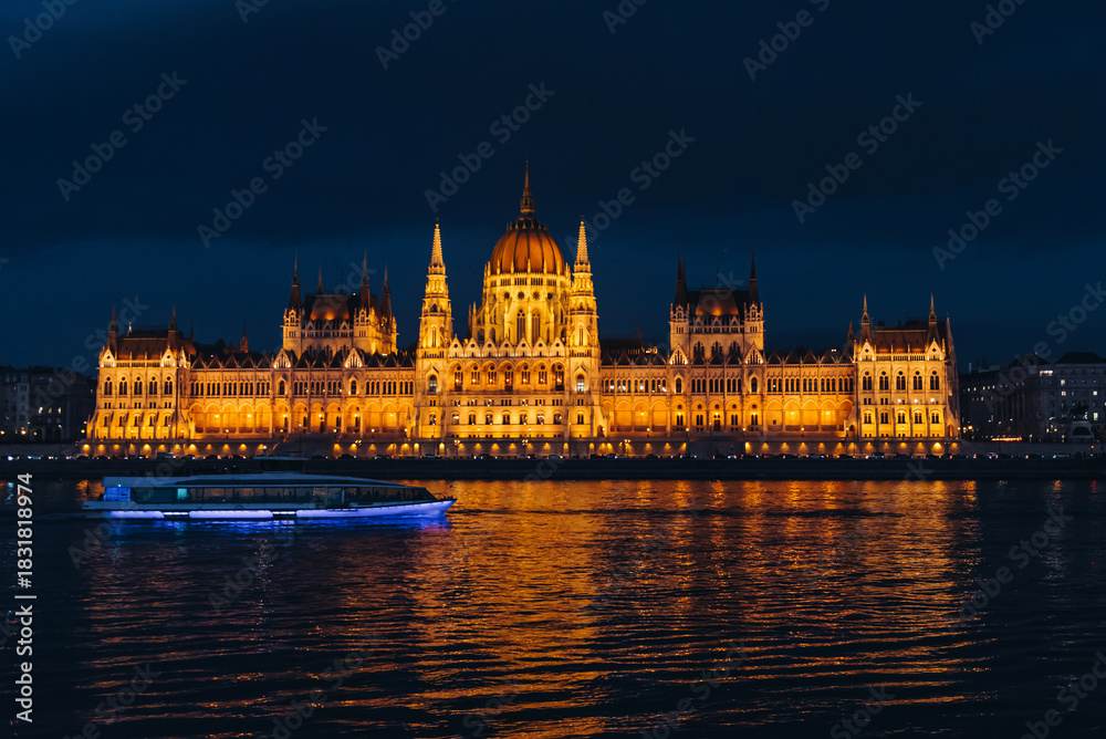 Fototapeta premium Budapest parliament at night with boat