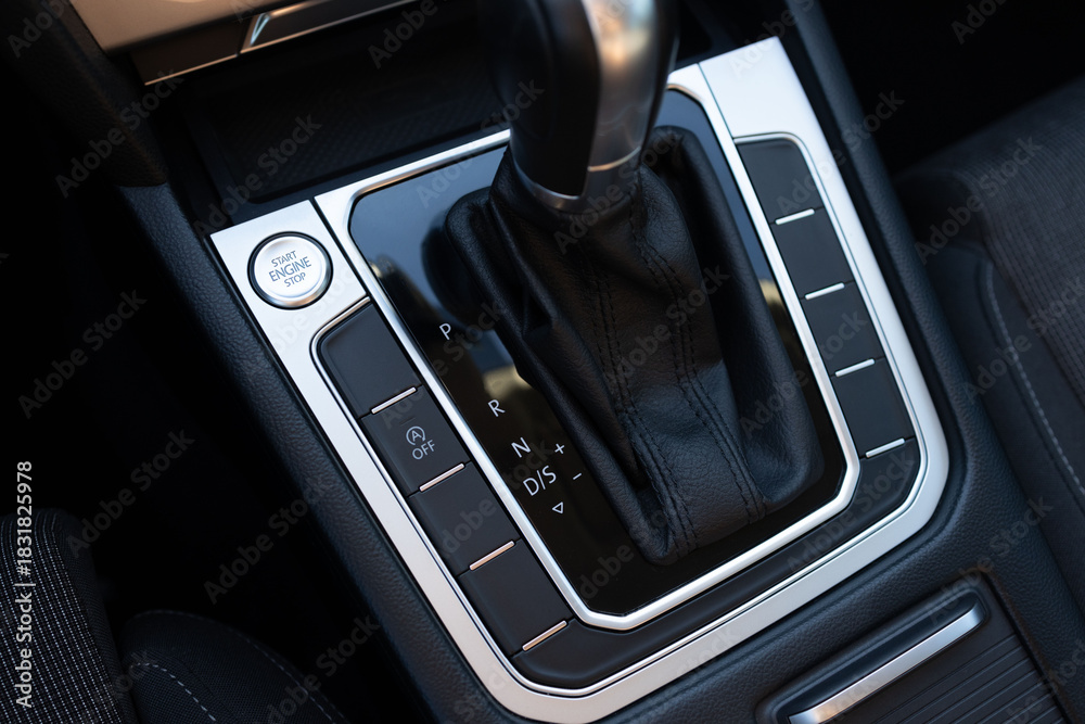Naklejka premium Start button to starting the car engine. Close-up of details of automatic transmission and gear stick. Automatic gear lever and gear shift. Handle of car gearbox control