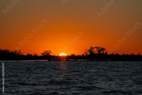 Atardecer con el sol en el horizonte en los esteros del Ibera, Corrientes,Argentina
