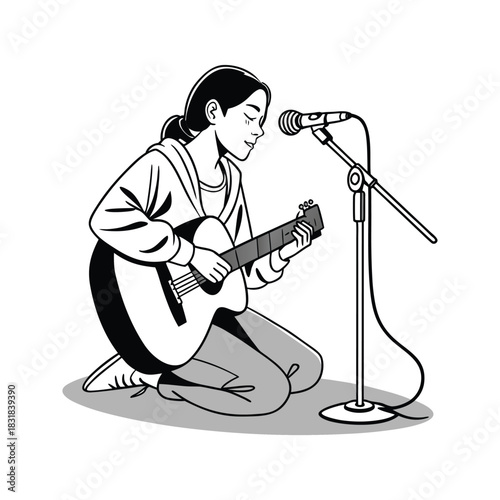 Young person playing acoustic guitar and singing into microphone on stage