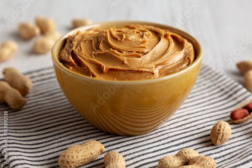 Konstfotografi Creamy Brown Peanut Butter in a Bowl, low angle view. Close-up.