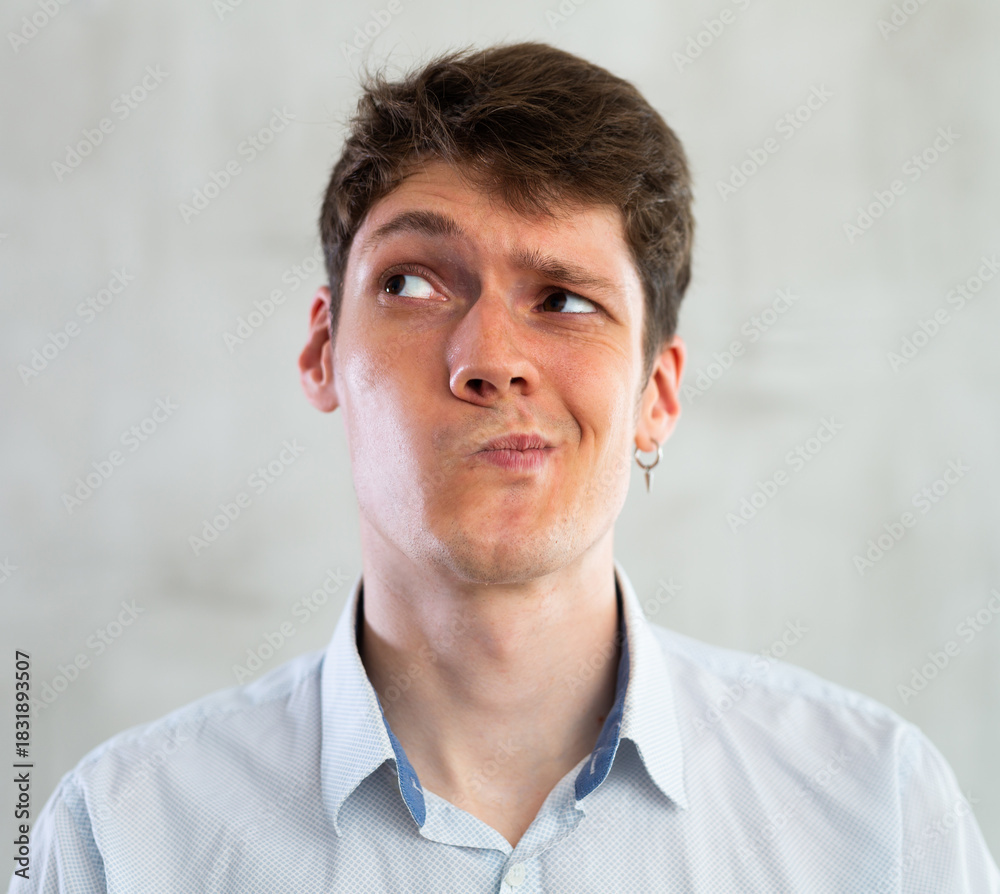 Obraz premium Emotions, people and positive concept man expresses different on gray background