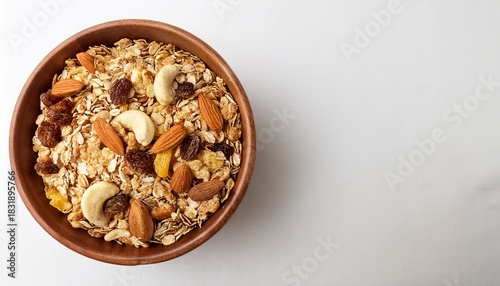 muesli bowl organic ingredients for healthy breakfast granola nuts dried fruits oatmeal whole grain flakes on white background copy space