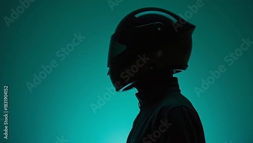 Helmeted silhouette against teal glow—minimalist profile and shadowed form evoke mystery, motion, and the quiet intensity of speed.
